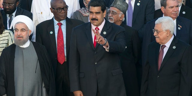 Iran's President Hassan Rouhani, front row, from left, Venezuela's President Nicolas Maduro, and Palestinian President Mahmoud Abbas, gather for an official group photo at the 17th Non-Aligned Movement Summit in Porlamar, on Venezuela's Margarita Island, Saturday, Sept. 17, 2016. (AP Photo/Ariana Cubillos)