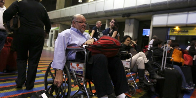 Dec. 15, 2013: Passengers lineup in front of the Air France desk after their flight to Paris was canceled at Simon Bolivar Airport in Maiquetia near Caracas, Venezuela.