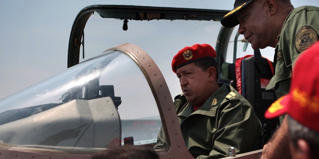 Venezuela's President Hugo Chavez checks a Chinese-made military plane during a ceremony at a military base.