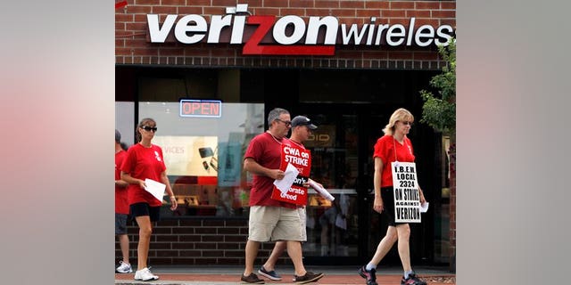 August 8: Striking Verizon workers picket in front of a Verizon Wireless store in Colonie, N.Y.