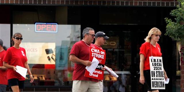 August 8: Striking Verizon workers picket in front of a Verizon Wireless store in Colonie, N.Y.