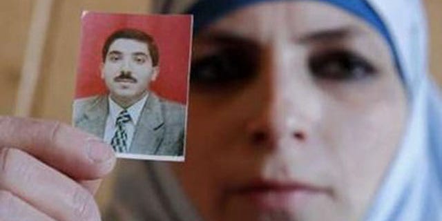 March 11, 2011: Veronica, wife of Dirar Abu Sisi, a Palestinian who disappeared last month in Ukraine, holds up her husband's photo during a meeting with journalists at the Islamic Centre in Kiev.