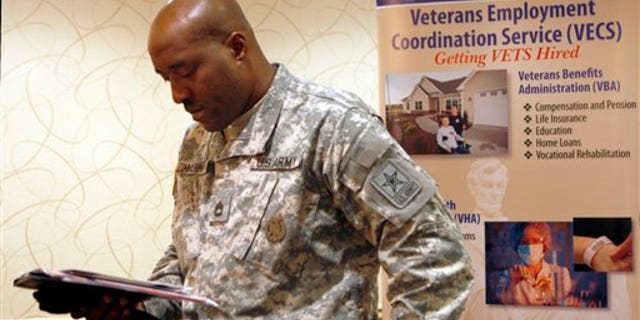 May 3: Army Sgt.1st Class Lonell Zimmerman, of Vineland, N.J., looks over some papers as he attends a job fair aimed at helping military and former military members transition to civilian jobs, in Cherry Hill, N.J.