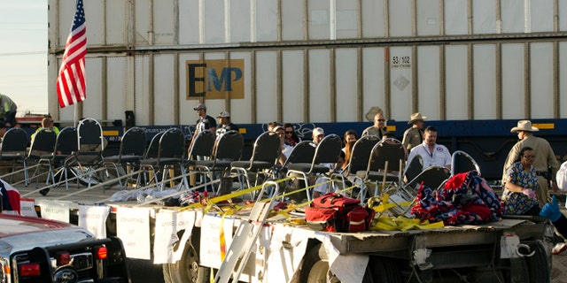 Nov. 15, 2012: In this file photo, authorities respond to an accident involving a trailer carrying wounded veterans that was struck by a train during a parade in Midland, Texas.