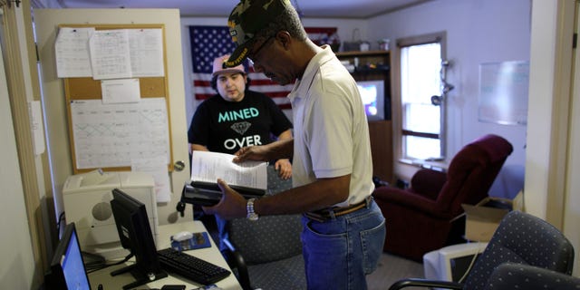 FILE: Undated: A military veteran gets help with his resume from an Iraq war veteran at the Midwest Shelter for Homeless Veterans in Wheaton, Illinois.
