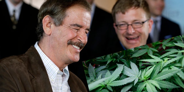 Former Mexican President Vicente Fox, left, speaks as Jamen Shively, CEO of Diego Pellicer, looks on during a news conference Thursday, May 30, 2013, in Seattle. (AP Photo/Elaine Thompson)
