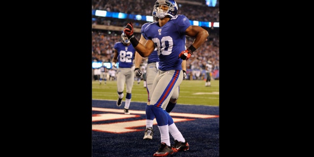 EAST RUTHERFORD, NJ - NOVEMBER 20: Victor Cruz #80 of the New York Giants celebrates after he scored on a 24-yard touchdown catch in the fourth quarter against the Philadelphia Eagles at MetLife Stadium on November 20, 2011 in East Rutherford, New Jersey. (Photo by Patrick McDermott/Getty Images)