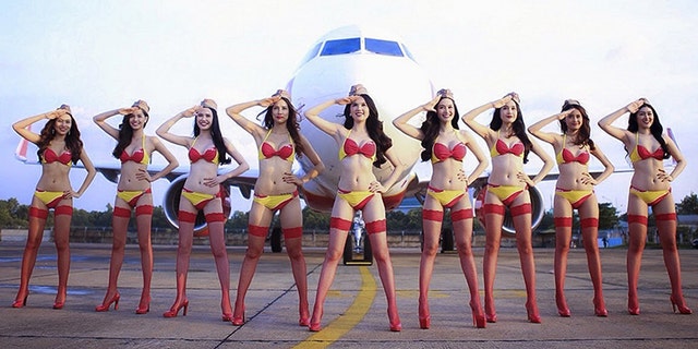 Models dressed in scantily-clad clothing put on an in-flight performance for Vietnam's under-23 soccer team Sunday, Jan. 28, 2018.