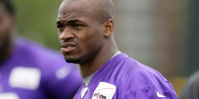FILE - In this July 28, 2014, file photo, Minnesota Vikings running back Adrian Peterson looks on during NFL football training camp in Mankato, Minn. Peterson acknowledges he struck his young son with a branch, but insists he did not commit a crime. That belief is to draw further attention this week when the case against the Vikings' star running back goes before a Texas judge. (AP Photo/Charlie Neibergall, File)
