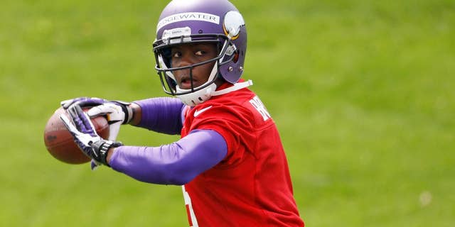 Quarterback Teddy Bridgewater drops back to pass during Minnesota Vikings minicamp in Eden Prairie, Minn., Friday, May 16, 2014. New Vikings coach Mike Zimmer set to work getting young players like Bridgewater, linebacker Anthony Barr and defensive backs Antone Exum and Kendall James up to speed on what will be expected of them in the NFL. (AP Photo/Ann Heisenfelt)