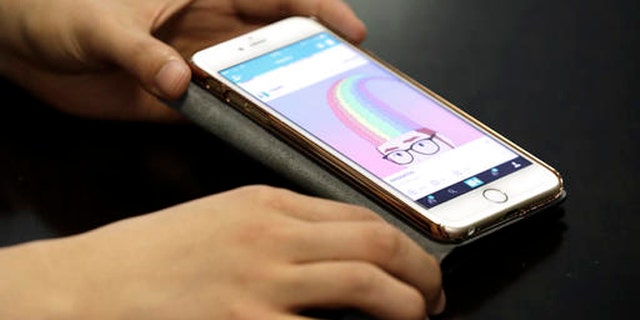 FILE - In this June 30, 2016, file photo, Hayatto Noguchi, Japanese Vine artist, shows his work on a smartphone during an interview with The Associated Press in Tokyo. Twitter has decided to shut down the Vine video app, which has been eclipsed by the likes of Instagram and Snapchat even as it remains beloved by a loyal fan base. (AP Photo/Eugene Hoshiko, File)