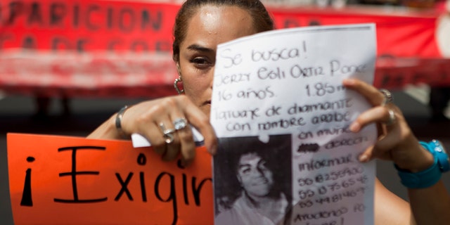 May 30: A woman holds up a sign with details of her recently disappeared relative during a protest in Mexico City.