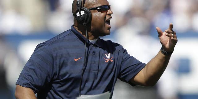 Virginia head coach Mike London reacts to a call in the second quarter during an NCAA college football game against Brigham Young, Saturday, Sept. 20, 2014, in Provo, Utah. (AP Photo/Rick Bowmer)