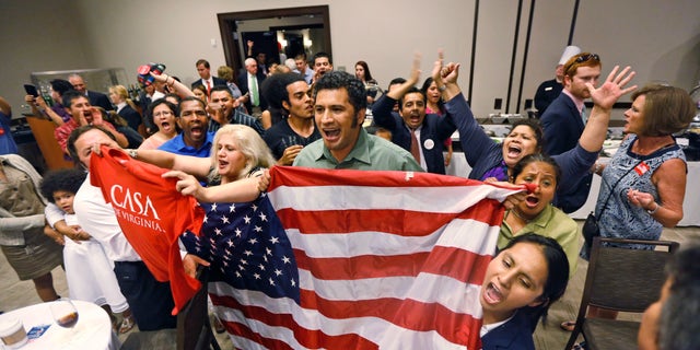 Immigration reform supporters crash the primary-night party of House Majority Leader Eric Cantor, R-Va., after he delivered a concession speech in Richmond, Va., Tuesday, June 10, 2014. Cantor lost in the GOP primary to tea party candidate Dave Brat. (AP Photo/Steve Helber)