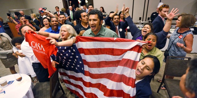 Immigration reform supporters crash the primary-night party of House Majority Leader Eric Cantor, R-Va., after he delivered a concession speech in Richmond, Va., Tuesday, June 10, 2014. Cantor lost in the GOP primary to tea party candidate Dave Brat. (AP Photo/Steve Helber)