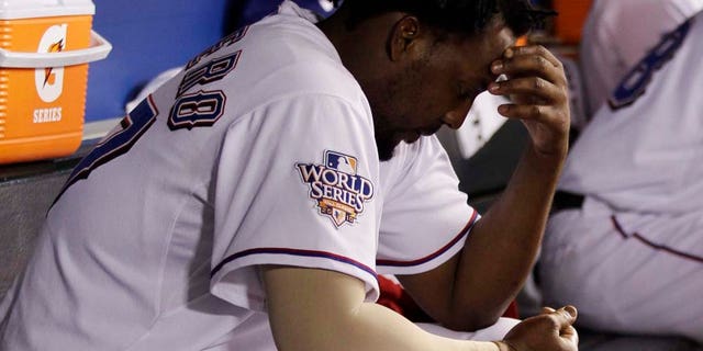 Texas Rangers' Vladimir Guerrero sits in the dugout after striking out during the seventh inning of Game 4 of baseball's World Series against the San Francisco Giants Sunday, Oct. 31, 2010, in Arlington, Texas. (AP Photo/David J. Phillip)