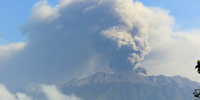 Mount Raung spews volcanic material into the air.