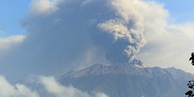 Mount Raung spews volcanic material into the air.