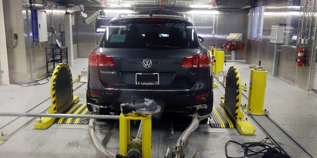 FILE - In this Oct. 13, 2015 file photo, a Volkswagen Touareg diesel is tested in the Environmental Protection Agency's cold temperature test facility in Ann Arbor, Mich. The U.S. government says Volkswagen cheated a second time on emissions tests, programming about 10,000 cars with larger diesel engines, including the 2014 Touareg, 2015 Porsche Cayenne and the 2016 Audi A6 Quattro, A7 Quattro, A8 and Q5, to emit fewer pollutants during testing than in real-world driving conditions. (AP Photo/Carlos Osorio, File)