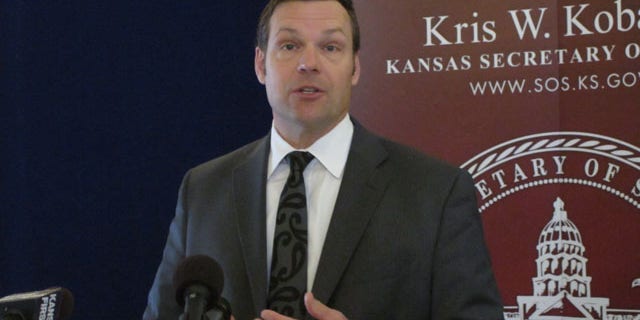 March 19, 2014: Kansas Secretary of State Kris Kobach discusses a federal judge's ruling ordering the federal government to help Kansas and Arizona enforce their proof-of-citizenship requirements for new voters. Kobach and Arizona Secretary of State Ken Bennett filed a lawsuit over the issue. (AP Photo/John Hanna)