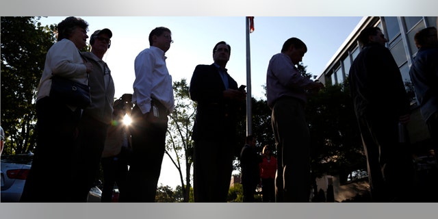 WAUWATOSA, WI - JUNE 5: Voters wait in line to cast their ballots outside Jefferson School to vote in the gubernatorial recall election June 5, 2012 in Wauwatosa, Wisconsin. Voters were lined up before the polls opened at 7:00 AM to decide on the recall race between the Republican Wisconsin Gov. Scott Walker and Democratic Milwaukee Mayor Tom Barrett. (Photo by Tom Lynn/Getty Images)