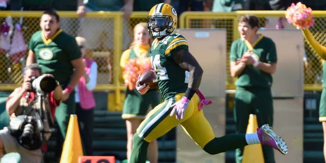 Sunday, Oct. 11: Green Bay Packers cornerback Quinten Rollins returns an interception for a touchdown in the first quarter against the St. Louis Rams at Lambeau Field in Green Bay, Wis.