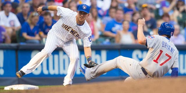 Friday, July 22, 2016: Milwaukee Brewers third baseman Hernan Perez (left) tags out Chicago Cubs third baseman Kris Bryant at third base during the second inning at Miller Park. The Brewers lost 5-2.