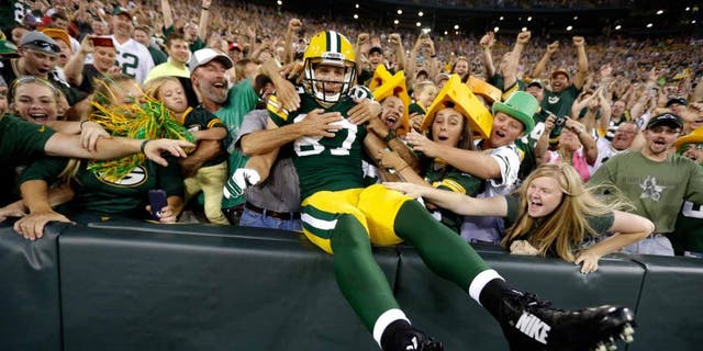 Friday, August 22: Green Bay Packers wide receiver Jordy Nelson celebrates with fans after scoring a touchdown against the Oakland Raiders.
