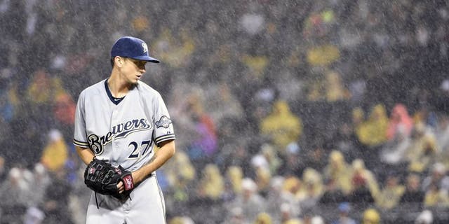 Saturday, Sept. 12, 2015: Milwaukee Brewers pitcher Zach Davies gets set to throw against the Pittsburgh Pirates during a rain storm in the third inning of in Pittsburgh.