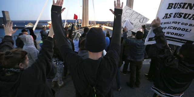 Feb. 21, 2015: Protesters hold up their hands and signs on the cable bridge.