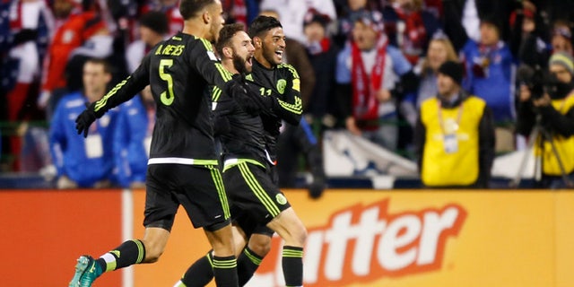 From left to right, Mexico's Diego Reyes, Miguel Layun and Carlos Vela celebrate their goal against the United States during the first half of a World Cup qualifying soccer match Friday, Nov. 11, 2016, in Columbus, Ohio. (AP Photo/Jay LaPrete)