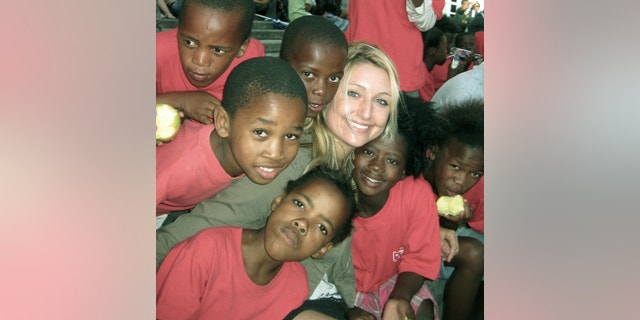 Whitney Johnson, surrounded by the children of Ubuntu.
