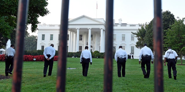 Sept. 20, 2014: Uniformed Secret Service officers walk along the lawn on the North side of the White House in Washington, D.C.