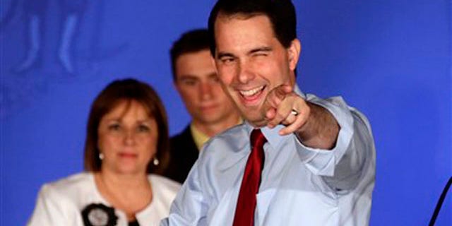 FILE: Wisconsin Republican Gov. Scott Walker reacts at his victory party in Waukesha, Wis., after defeating Democratic challenger Tom Barrett in a special recall election.