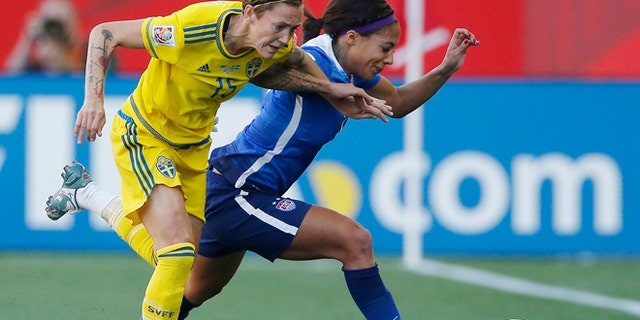 Sweden's Therese Sjogran (15) and United States' Sydney Leroux chase down the ball during first-half FIFA Women's World Cup soccer game action in Winnipeg, Manitoba, Canada, Friday, June 12, 2015. (John Woods/The Canadian Press via AP) MANDATORY CREDIT