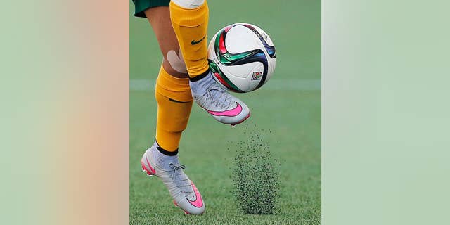 FILE - In this June 12, 2015, file photo, Australia's Samantha Kerr controls the ball during the second half of a FIFA Women's World Cup soccer game against Nigeria in Winnipeg, Manitoba, Canada. The fields are heating up, there are little black rubber pellets everywhere, and feet are covered with blisters.  The use of artificial turf at this year’s tournament in Canada has been a contentious issue with the players since it was included in the nation’s bid in 2011. (John Woods/The Canadian Press via AP, File)