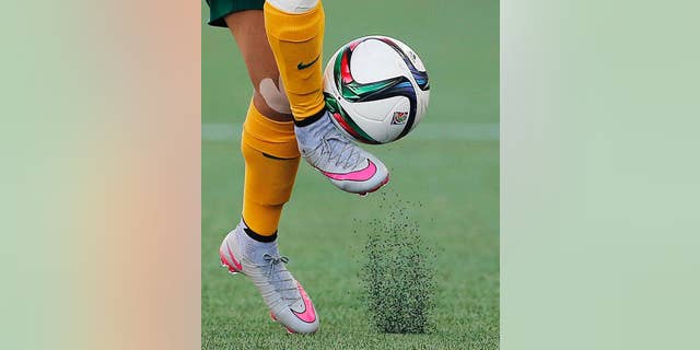 FILE - In this June 12, 2015, file photo, Australia's Samantha Kerr controls the ball during the second half of a FIFA Women's World Cup soccer game against Nigeria in Winnipeg, Manitoba, Canada. The fields are heating up, there are little black rubber pellets everywhere, and feet are covered with blisters. The use of artificial turf at this year’s tournament in Canada has been a contentious issue with the players since it was included in the nation’s bid in 2011. (John Woods/The Canadian Press via AP, File)