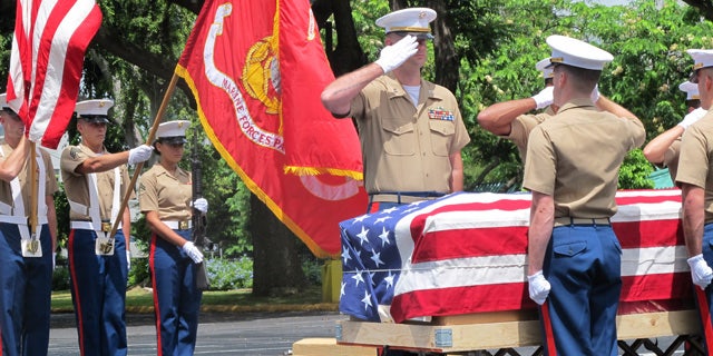 Sept. 24, 2015: United States Marines salute during a ceremony in Honolulu for the departure of 1st Lt. Alexander Bonnyman's remains. (AP Photo/Audrey McAvoy)
