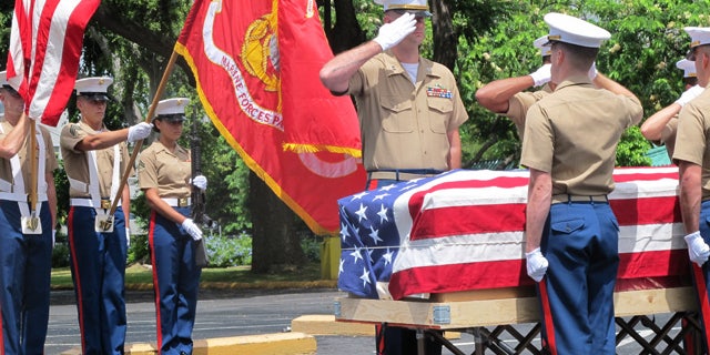 Sept. 24, 2015: United States Marines salute during a ceremony in Honolulu for the departure of 1st Lt. Alexander Bonnyman's remains. (AP Photo/Audrey McAvoy)