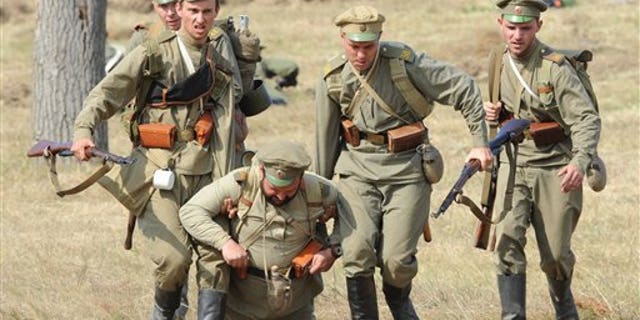 Actors dressed as Russian soldiers take part in the re-enactment of the 1914 Battle of Tannenberg in Szkotowo, Poland, Sunday, July 27, 2014, marking the 100th anniversary of the beginning of World War I. (AP Photo/Alik Keplicz)