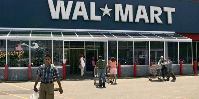 Shoppers enter and exit a Wal-Mart, in Walpole, Mass., Wednesday, May 11, 2005. Wal-Mart Stores Inc. reported a 14 percent increase in first-quarter earnings Thursday, May 12, 2005, but the results missed Wall Street estimates. The world's largest retailer also warned that second-quarter results would likely be lower than expected. (AP Photo/Steven Senne)