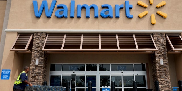 FILE - In this May 9, 2013 file photo, a worker pushes shopping carts in front of a Wal-Mart store in La Habra, Calif. Wal-Mart is turning to its marketing chief in China to shape how it relays its message to shoppers in the U.S. The worldâs largest retailer named Tony Rogers as chief marketing officer for the U.S. Friday, Dec. 18, 2015. He will report to Greg Foran, president and CEO of Wal-Martâs U.S. division starting in mid-January. (AP Photo/Jae C. Hong, File)