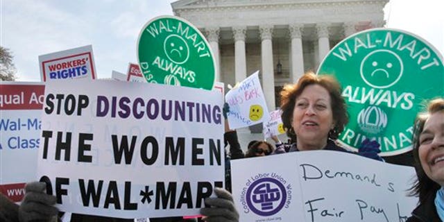 March 30: Protestors rally outside the Supreme Court in Washington, supporting plaintiffs in a case of women employees against Walmart.