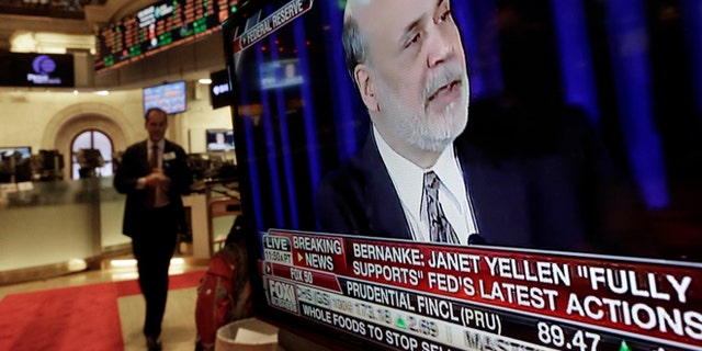 The news conference of Federal Reserve Chairman Ben Bernanke appears on a television screen at a trading post on the floor of the New York Stock Exchange, Wednesday, Dec. 18, 2013. The Federal Reserve has decided to reduce its stimulus for the U.S. economy because the job market has shown steady improvement. The Fed will trim its $85 billion a month in bond purchases by $10 billion starting in January. (AP Photo/Richard Drew)