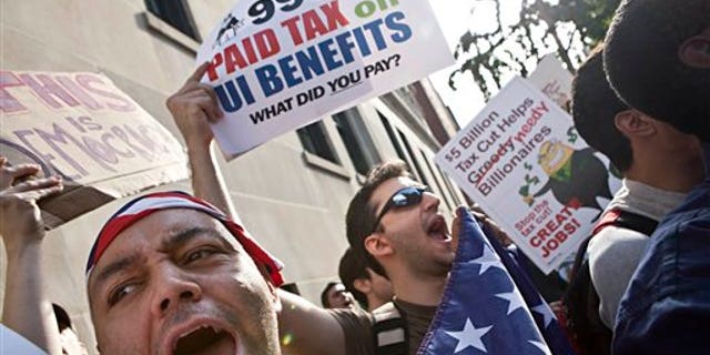 October 11: Protesters with the Occupy Wall Street movement wave signs and banners outside 1185 Park Avenue, home of Jamie Dimon, CEO of JP Morgan Chase, during a march in New York.