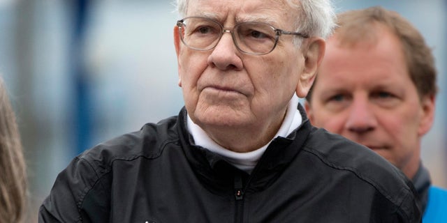 Investor Warren Buffett places a hand on his heart during the playing of the national anthem prior to launching a 5K run and walk organized by the Brooks Running Company, a Berkshire Hathaway subsidiary, in Omaha, Neb., Sunday, May 5, 2013. The Berkshire Hathaway shareholders meeting is being held this weekend in Omaha. (AP Photo/Nati Harnik)