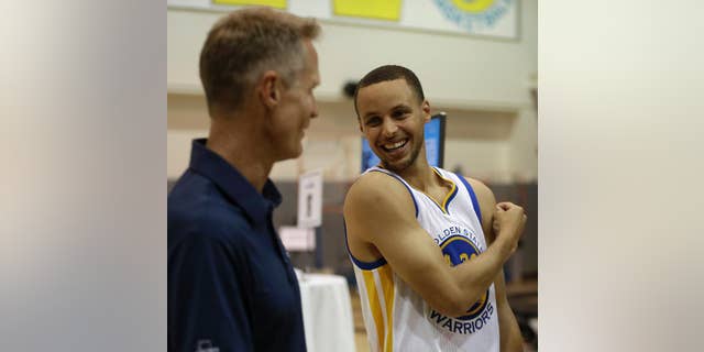 Golden State Warriors' Stephen Curry, right, with coach Steve Kerr.