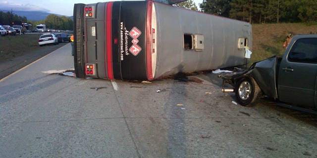 May 28: In this image provided by the Washington State Patrol a tour bus carrying fans home from a soccer game lies on it's side after crashing into a disabled pickup on the shoulder of Interstate 90 in central Washington Saturday evening, triggering a three-vehicle crash that killed two people and injured up to 15 others, authorities said. The bus carrying about 15 passengers was en route from Seattle, where the soccer game was held, to Moses Lake in Grant County. (AP/Washington State Patrol)