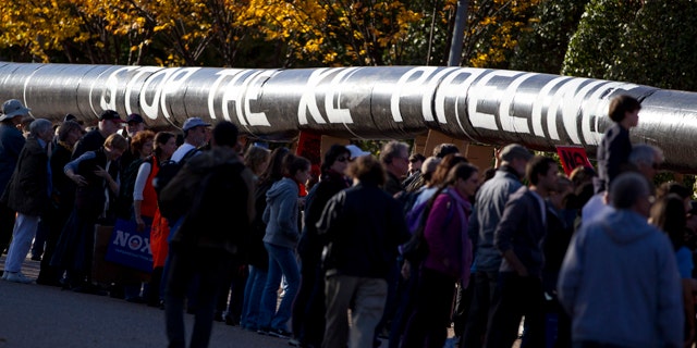 Nov. 6, 2011: Demonstrators march with a replica of a pipeline during a protest outside the White House to demand a stop to the Keystone XL oil pipeline.