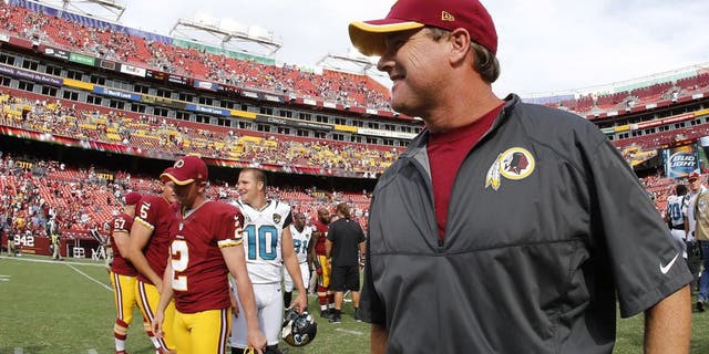 Sep 14, 2014; Landover, MD, USA; Washington Redskins head coach Jay Gruden (R) walks off the filed after the Redskins' game against the Jacksonville Jaguars at FedEx Field. The Redskins won 41-10. Mandatory Credit: Geoff Burke-USA TODAY Sports
